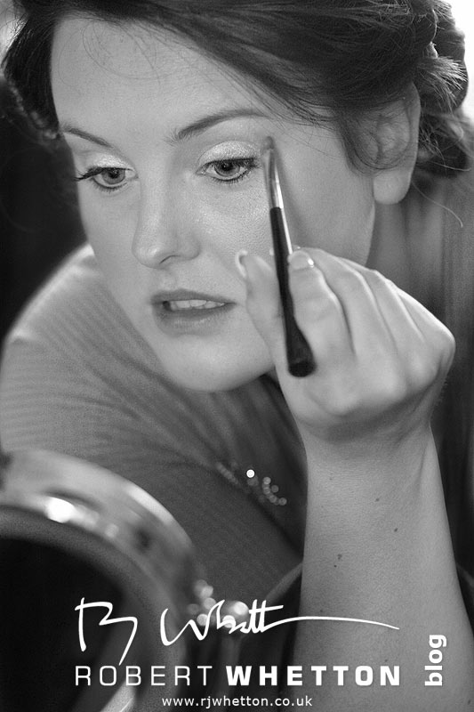 Wedding of Jo and Ben Christie at Kingston Country Courtyard, Swanage Jo doing make-up - Dorset Wedding Photographer Robert Whetton