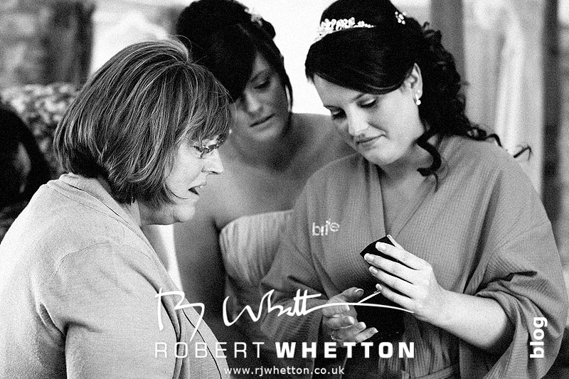 Wedding of Jo and Ben Christie at Kingston Country Courtyard, Swanage Jo with her mum and sister, presents - Dorset Wedding Photographer Robert Whetton