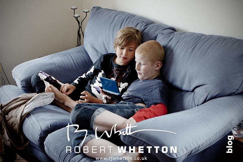 Wedding of Leah and Neil at St Marys, West Moors Boys playing on Nintendo DS - Dorset Wedding Photographer Robert Whetton