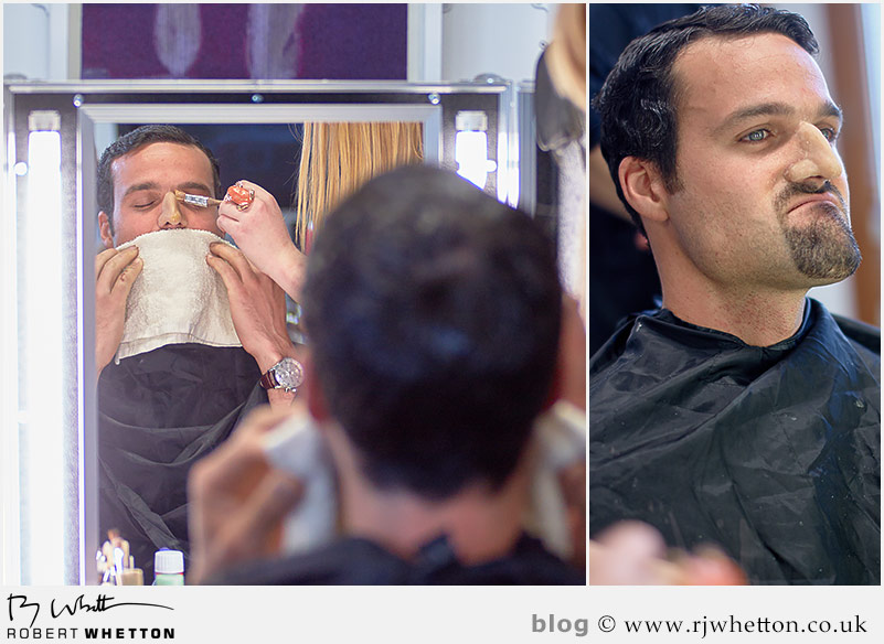 Make-up artist Sarah cleans the 'flash' off of the nose and begins work to blend it to the rest of Denzil's face Yes Sir Boss - Not Guilty Production Still - Production Photography Dorset