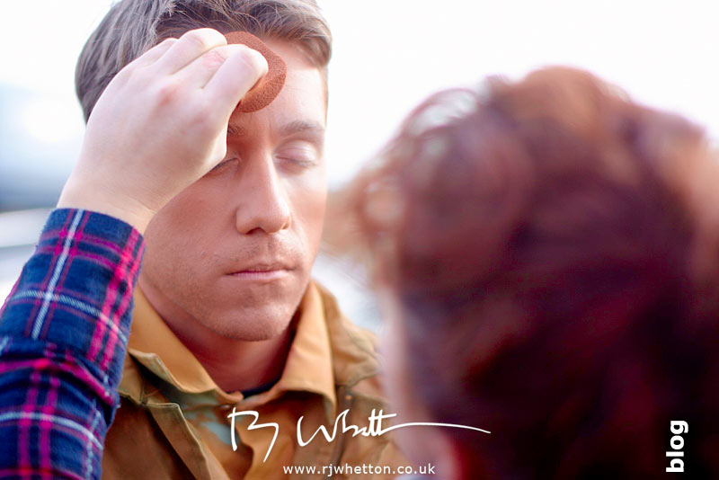 Orange army man has make-up applied Orange army man has make-up applied - Production Photography Dorset
