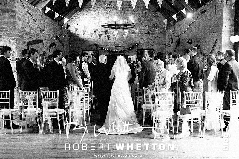 Wedding of Jo and Ben Christie at Kingston Country Courtyard, Swanage Walking down the isle - Dorset Wedding Photographer Robert Whetton