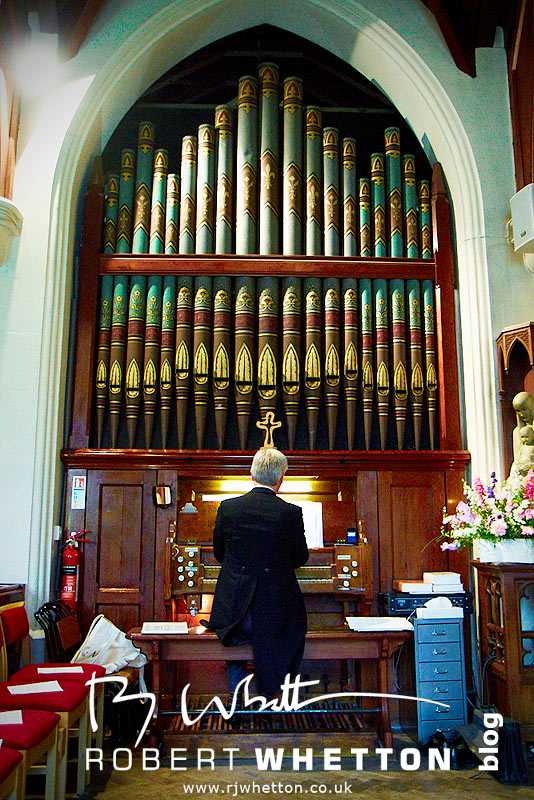 Wedding of Leah and Neil at St Marys, West Moors putting on tie - Dorset Wedding Photographer Robert Whetton