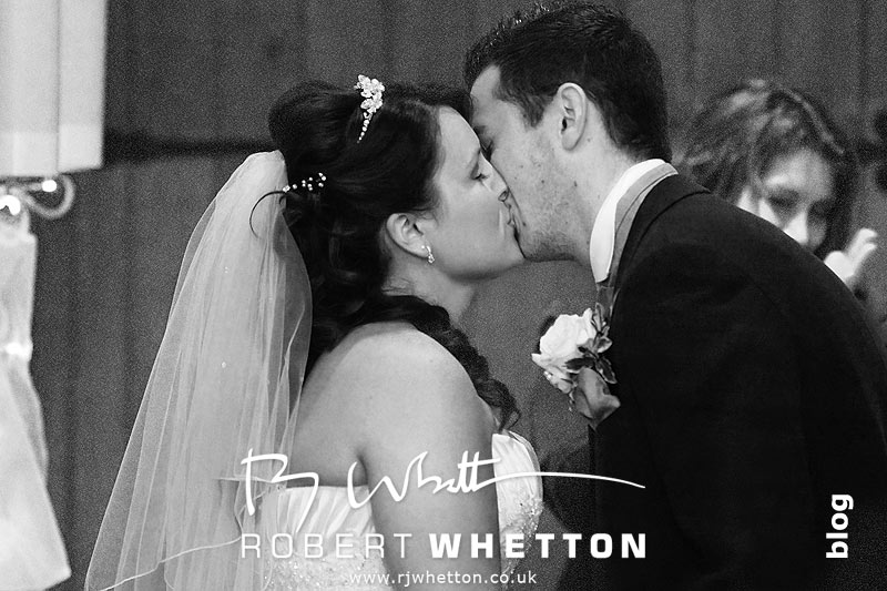 Wedding of Jo and Ben Christie at Kingston Country Courtyard, Swanage First kiss as Mr and Mrs - Dorset Wedding Photographer Robert Whetton