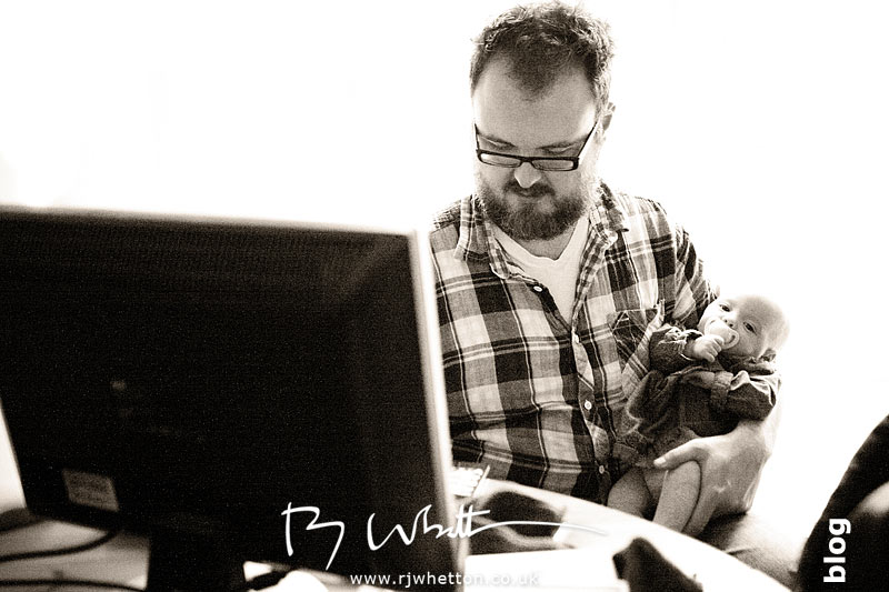 Who says men cant multi-task? Dom works while cuddling Scout Dom works on the computer with Scout asleep in his arm - Baby Portraits - Professional Portraits Dorset