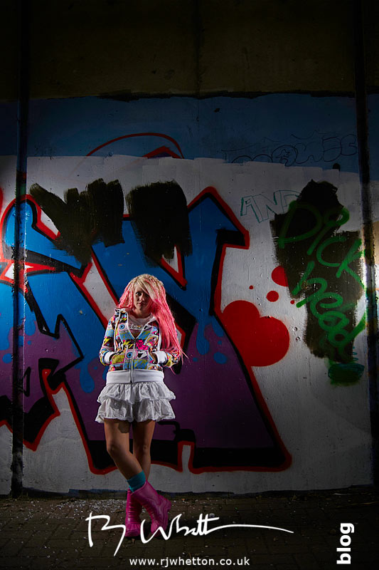 Wide angle of Pixie against a wall Wide angle of Pixie against a graffiti'd wall - Professional Portraits Dorset
