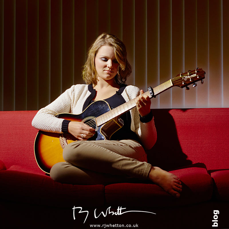 Millie posing with guitar on sofa Millie Taylor on sofa