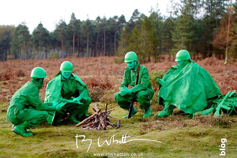 Green army men huddled around camp fire Green army men huddled around camp fire - Production Photography Dorset