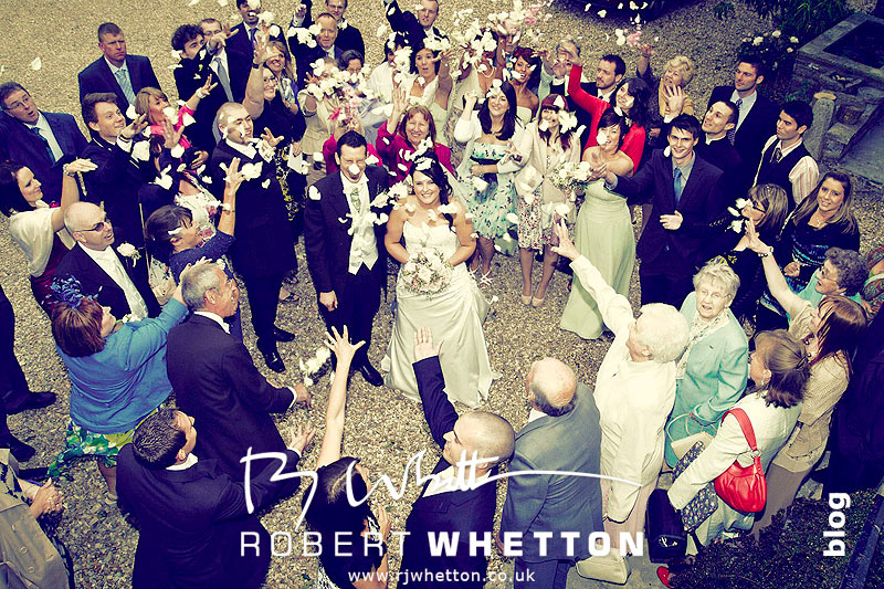 Wedding of Jo and Ben Christie at Kingston Country Courtyard, Swanage Throwing the confetti - Dorset Wedding Photographer Robert Whetton
