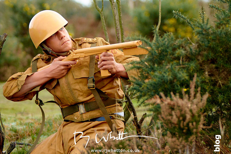Orange army man shooting at green army Orange army man shooting at green army - Production Photography Dorset
