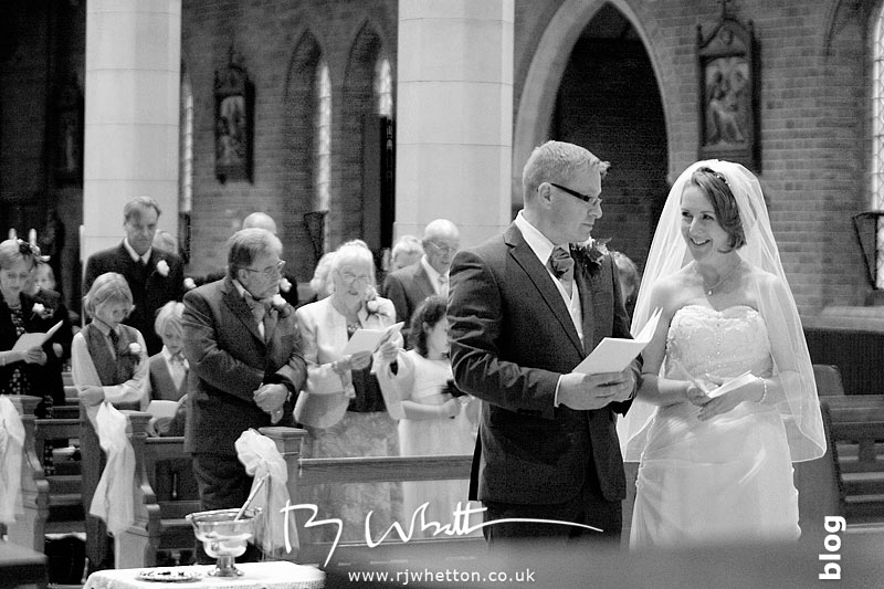 Darren and Rebecca exchange a glance during the service Darren and Rebecca exchange a glance during the service - Professional Wedding Photography Dorset