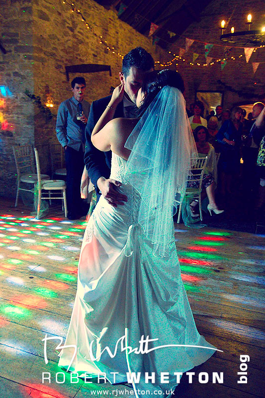 Wedding of Jo and Ben Christie at Kingston Country Courtyard, Swanage First dance kiss - Dorset Wedding Photographer Robert Whetton