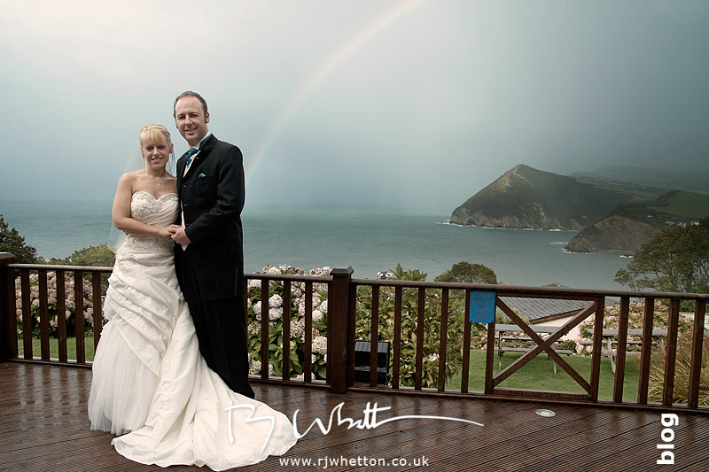 North Devon Wedding with Matt Fryer -Lynsey and Ash on the balcony with a rainbow in-between the rain
