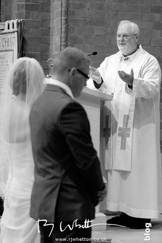 Father Denis giving the married couple some advice Father Denis giving the married couple some advice - Professional Wedding Photography Dorset