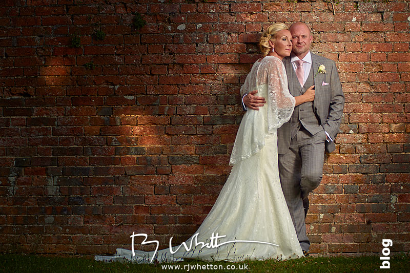 Stacy and Darren posing infront of an old wall with great textures Sharon and Greg posing in front of an old wall at The East Close Hotel, Dorset - Wedding Photography Dorset