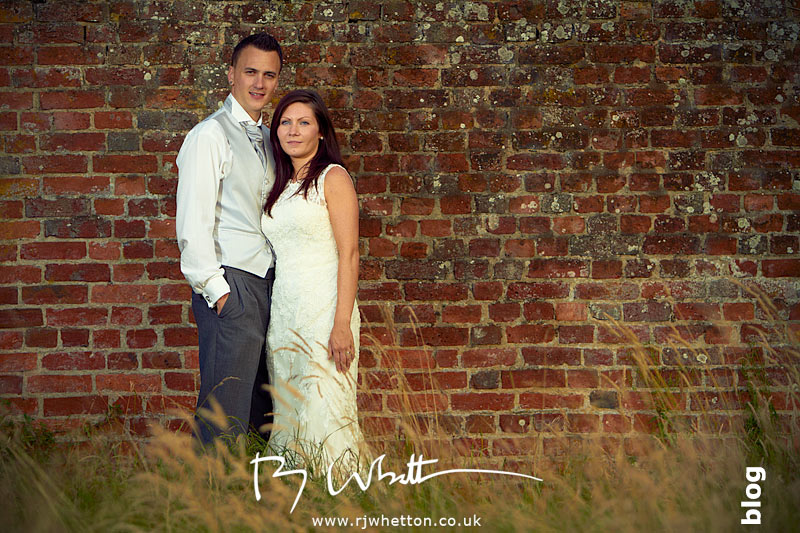 Stacy and Darren posing infront of an old wall with great textures Stacy and Darren posing in front of an old wall in Christchurch, Dorset - Wedding Photography Dorset